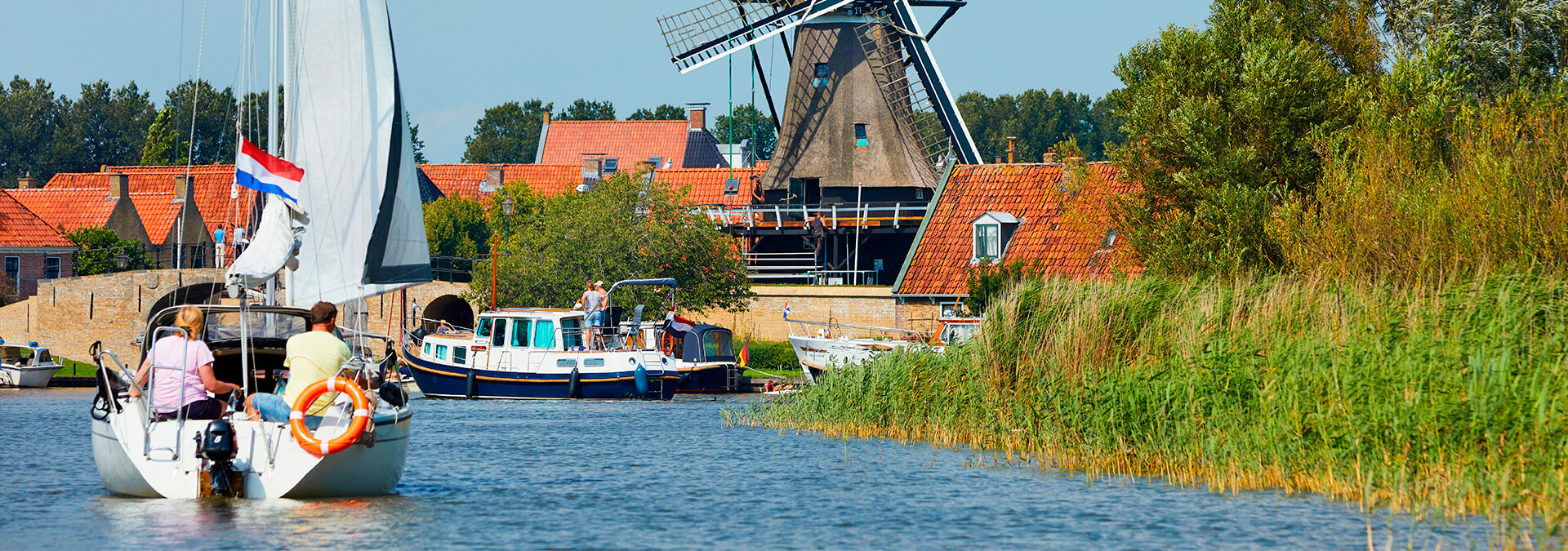 Dutch sailing boats and windmill